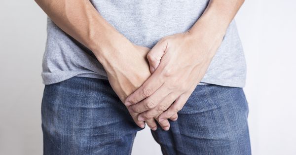 Man holding crotch.