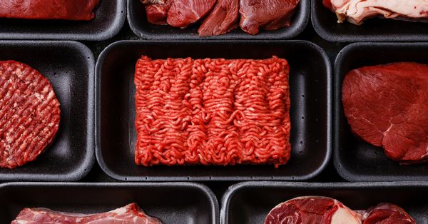 Raw meat displayed in containers.