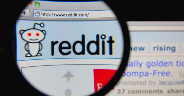 magnifying glass over Reddit homepage
