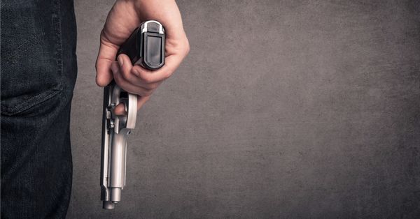 Close-up of hand holding gun