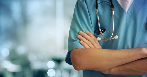 Health care professional with stethoscope, arms folded