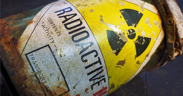 Worn metal container with "RADIOACTIVE" printed across it