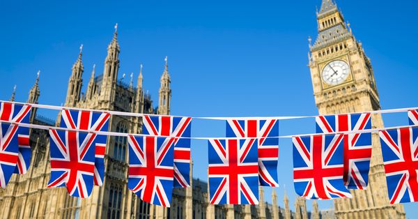 Union Jack flags strung across a road in front of Big Ben