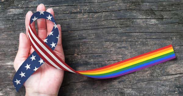 A ribbon half in U.S. flag colors and half in LGBTQ Pride colors
