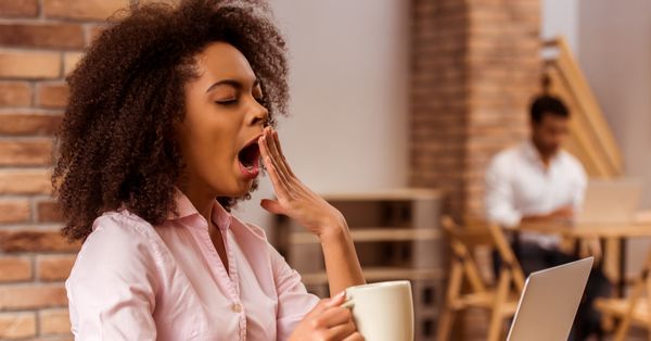 Woman wearing pink shirt yawning