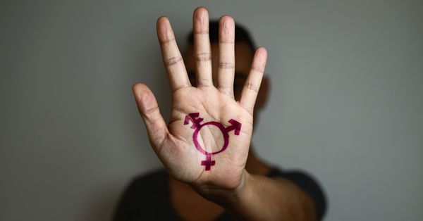 Person with transgender symbol drawn on palm