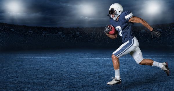 American football player running across a stylized field at night