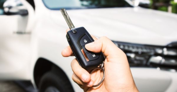 hand holding car key remote