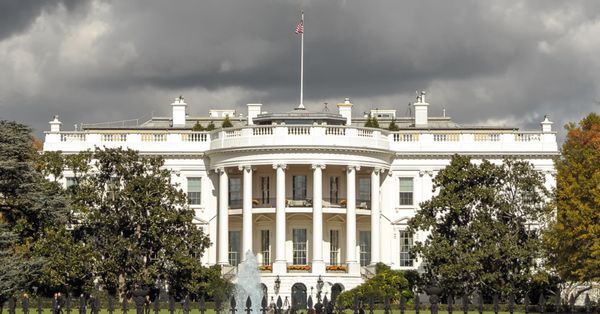 Exterior shot of White House in Washington, D.C., under a cloudy sky.