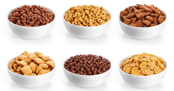 Various bowls of breakfast cereals against a white background.