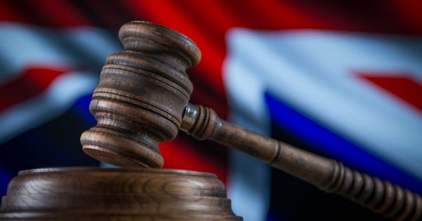 Gavel with British flag background.