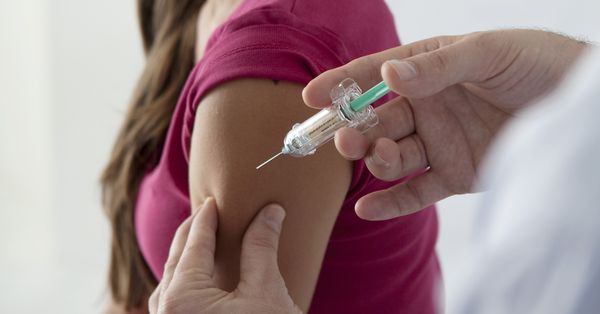 Young woman receiving an injection.