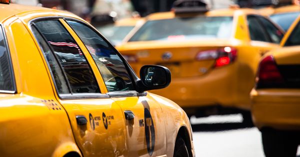 Yellow cab speeds through Times Square in New York, NY, USA.