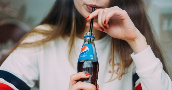 Woman drinking Pepsi soda