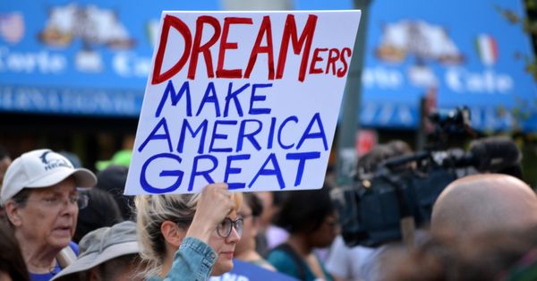 Protester holding sign reading: "DREAMers Make America Great"