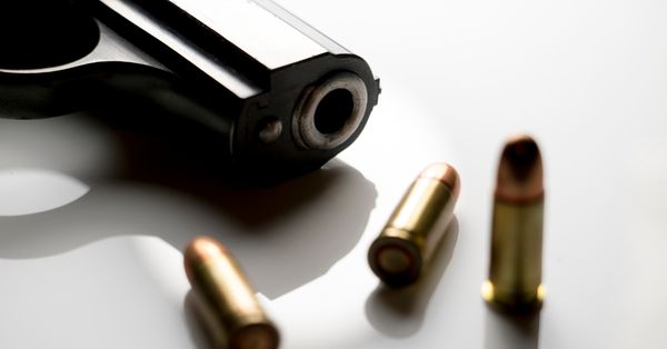 Close-up of a gun muzzle with bullet casings.
