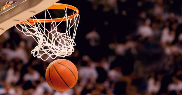 Basketball going through a hoop.