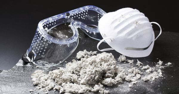 Concept piece showing asbestos alongside safety goggles and a mask.