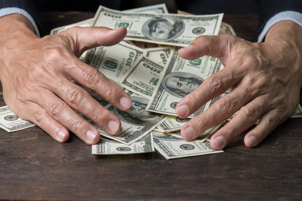Close-Up Of A Person With A Load Of Money