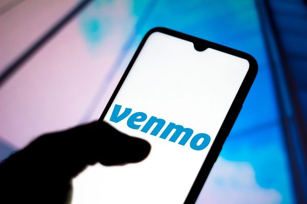 The Venmo logo can be read on a phone screen.