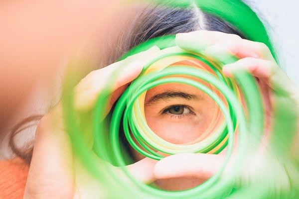 girl looking through a spiral of colors