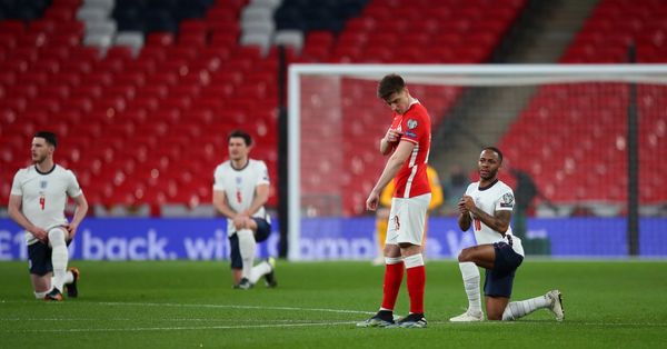 Soccer players taking a knee before a match