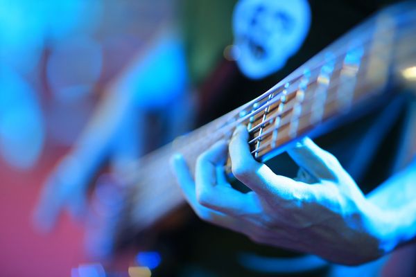Close up of man hand playing guitar.
