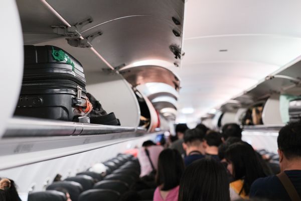 A story about an older woman who flew with drugs and got caught after landing at Dubai International Airport (DXB) cautions against touching other people's luggage for fear of being implicated in crimes, based on fingerprints on the baggage.
