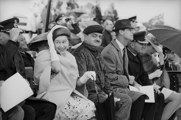 Queen Elizabeth II and others feel the downdraft from a helicopter at Winnipeg during a royal tour of Canada, July 1970. (Photo by David Cairns/Express/Getty Images)