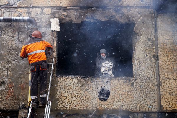 DONETSK, UKRAINE - FEBRUARY 9: A woman cleans out her damaged apartment in the area near a chemical plant which has suffered artillery shellings on February 09, 2015 in Donetsk, Ukraine. A missile exploded overnight on February 8, 2015 near a chemical plant producing weaponry in a northern suburb of Donetsk, causing a large fireball. Four apartments were burned and many others severely damaged. The shelling of the area continued this morning. (Photo by Pierre Crom/Getty Images)