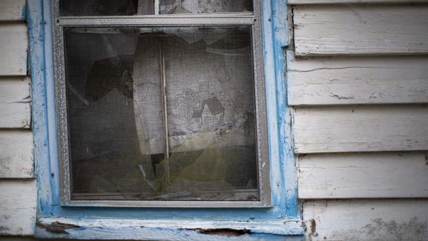An abandoned house from the Depression era painted in southern Gullah Haint blue and white