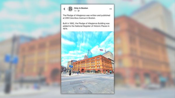 A screenshot of a Facebook post from Only In Boston says, "The Pledge of Allegiance was written and published at 209 Columbus Avenue in Boston. Built in 1892, the Pledge of Allegiance Building was added to the National Register of Historic Places in 1974." Below it is a picture of an orange building in a city with an American flag on top. The background is the picture of the city filling the entire frame.