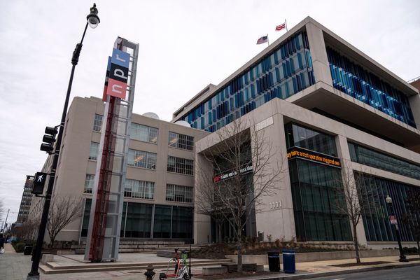 A large concrete building with a large NPR sign on it is photographed.