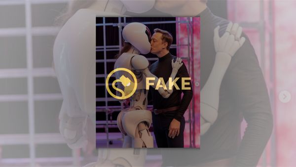 A white man kisses a robot with long brown hair.
