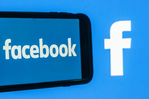 A phone that says Facebook is next to the Facebook logo.