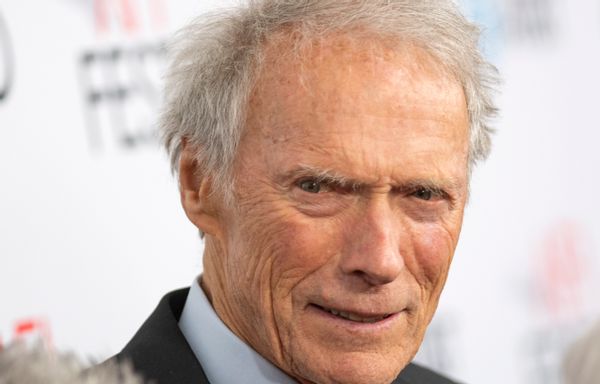 A white man smiles looking towards the camera.