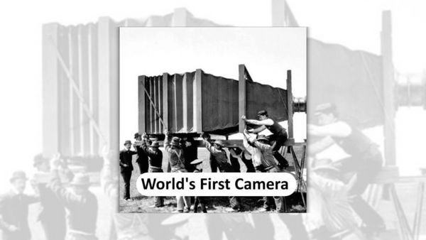 A black-and-white photo shows a massive camera, with many people surrounding it. At the bottom of the photo, it says, "World's First Camera."