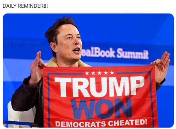 A white man holds a flag that says, 