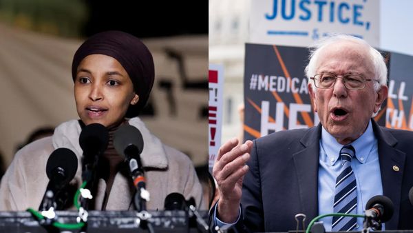 A woman and a man talk in front of microphones attached to podiums. On the left, a Black woman is speaking wearing a hijab and coat. On the right, a white man is speaking wearing a blue suit.