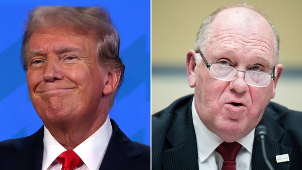 An image of a white man smiling is next to another white man sitting down who is speaking behind a mic. Both are wearing black suits.