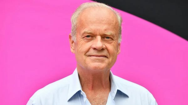 A white man wearing a white shirt looks forward.