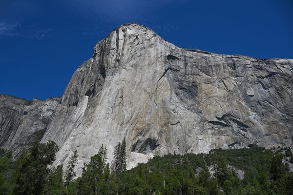 A large mountain vista amid a blue sky. 