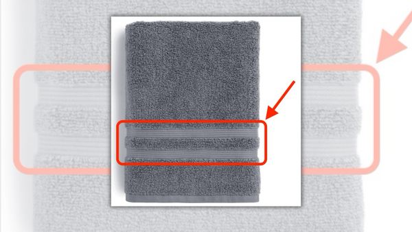 An image of a gray towel with a red rectangle highlighting its woven strip.