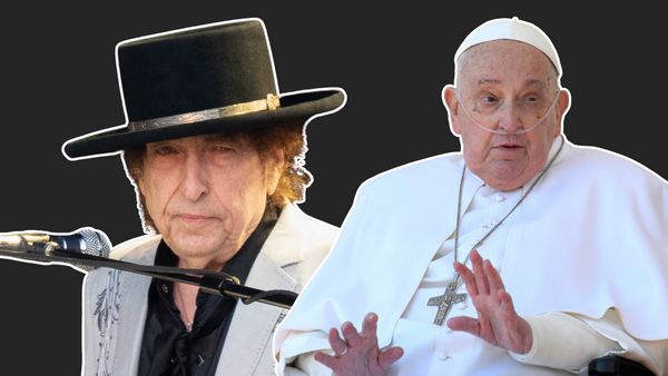 A white man wearing a black top hat looks at the camera. He is pictured next to a white man wearing a white robe and cross around his neck.