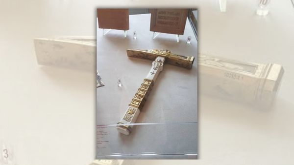 An image of an ornate silver and golden hammer. 