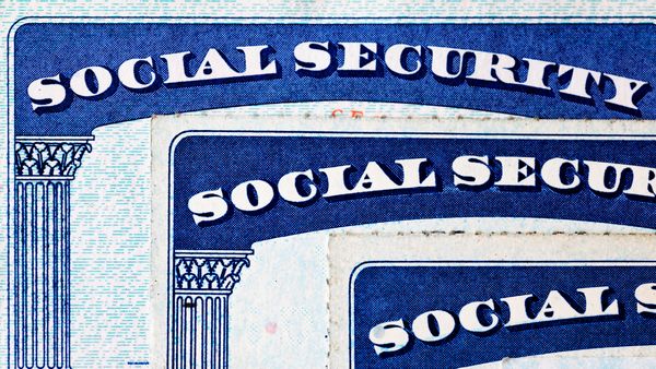 Three blue Social Security cards are stacked on top of each other.