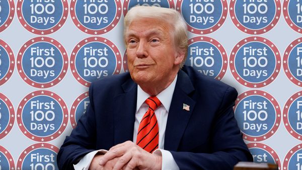 A white man wearing a blue suit is pictured in front of sickers that say First 100 Days. A light blue background is behind the stickers.