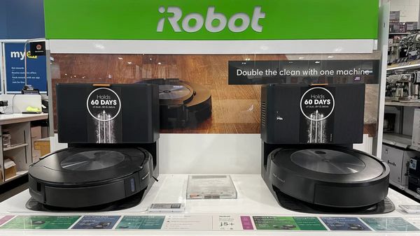 Two robot vacuums are displayed. Above, white text on a green sign says, "Robot."