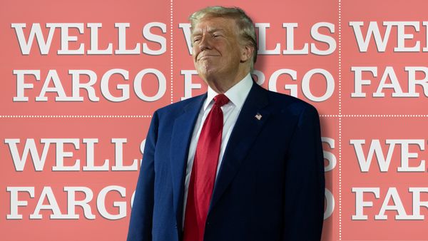 A white man wearing a blue suit is pictured in front of red signs with white text that says WELLS FARGO.