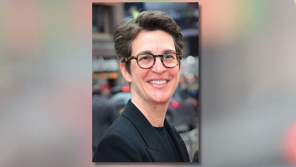 A white woman smiles at the camera.